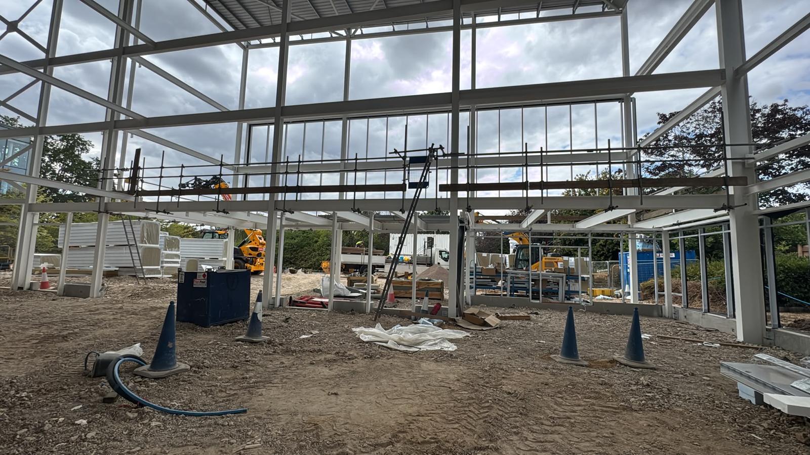 Internal edge protection barrier across an open mezzanine edge inside a steel framed commercial unit