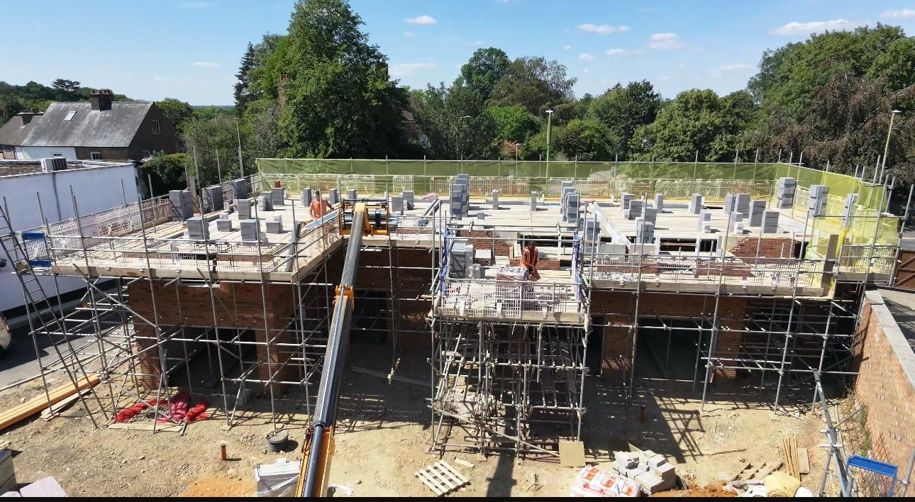 New build scaffolding with edge protection and safety netting around a block under construction